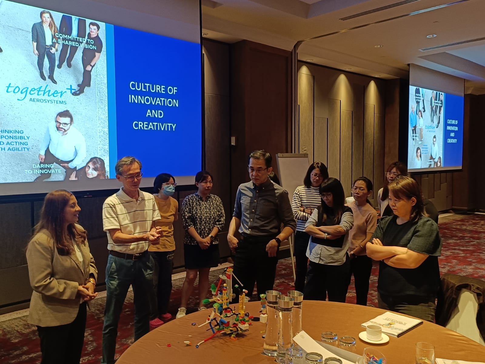 Team collaboration activity during a corporate training program in Singapore conducted by TEI trainers