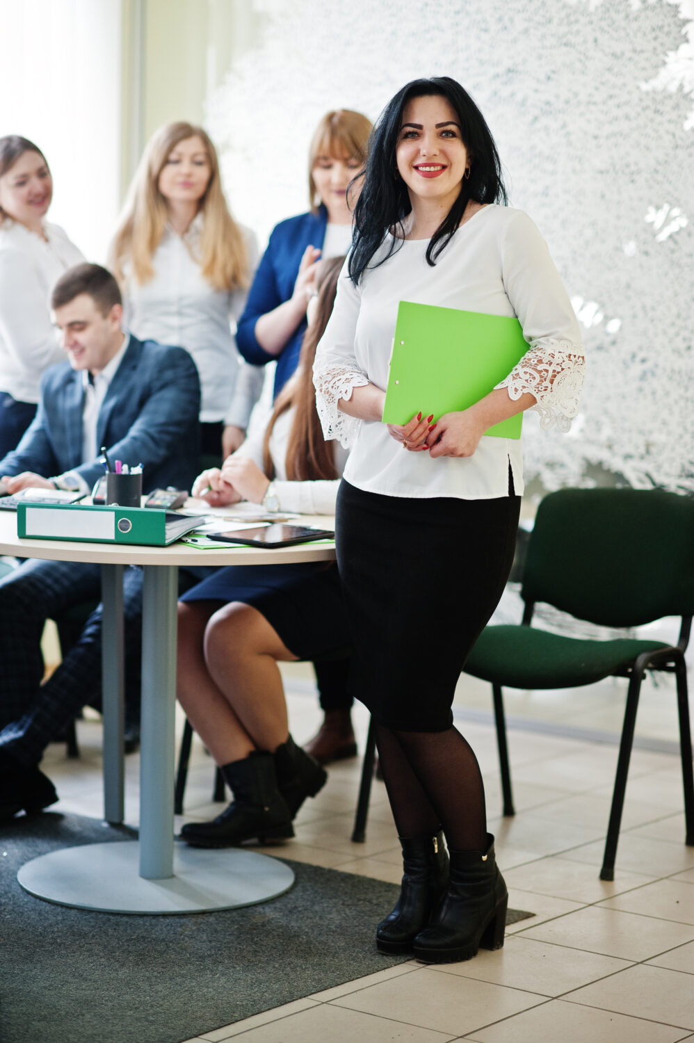 Colleagues laughing and interacting while solving a fun escape room challenge at a team-building event