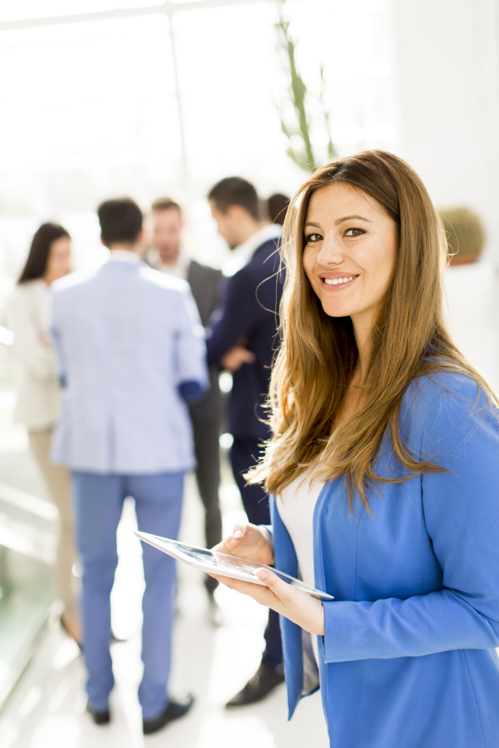 Employees gathered around a table, creating a blueprint for a group task during a team-building workshop
